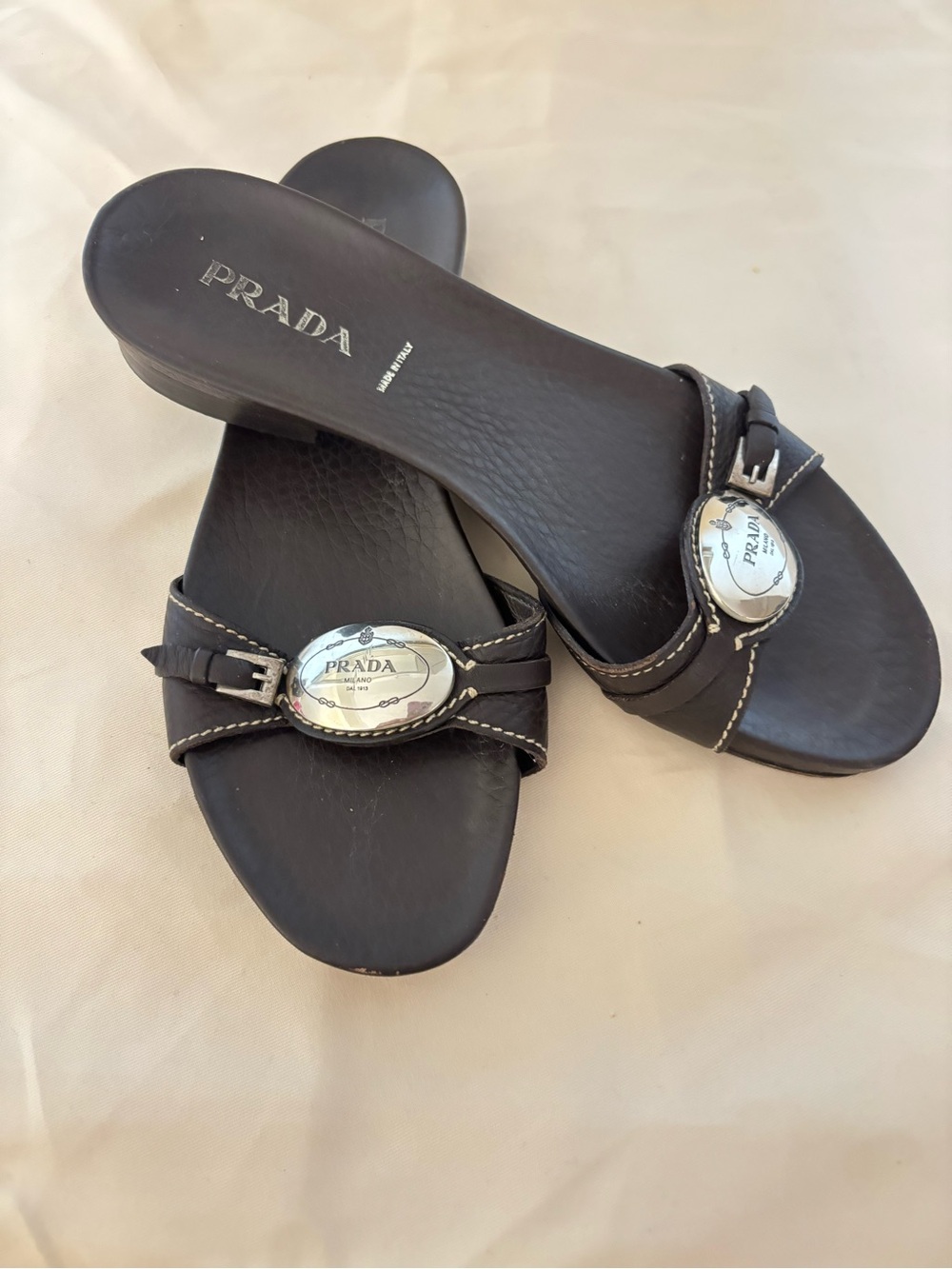 Prada Black Leather Slide Mules with Silver Logo Medallions